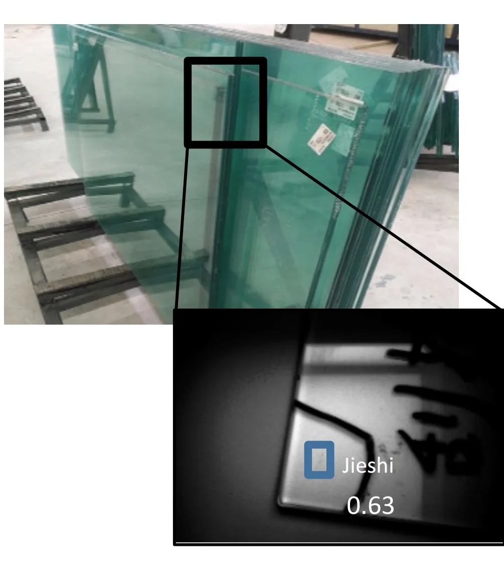 Sheets of flat glass with an inset close-up of a detected stone inclusion, confidence 0.63